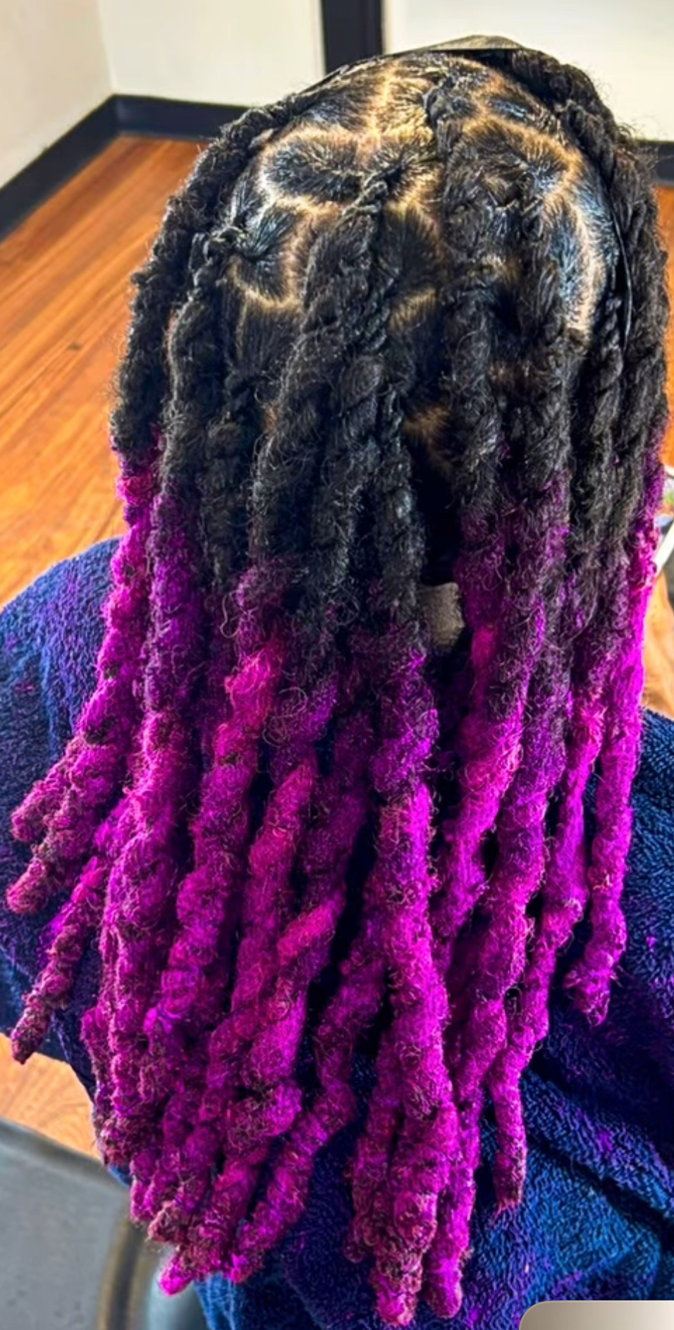 Locs with a vivid magenta ombre color