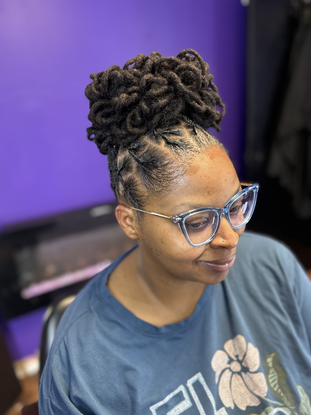 Elegant loc updo with soft pin curls styled at IAmHair Company Salon in Stockbridge, GA